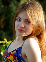 Erotic picture of Klarissa shows off her bushy pussy as she poses outdoors.