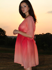 Erotic picture of Newcomer Lucie strips outdoors baring her sweet tits and trimmed pussy.