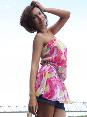 Erotic picture of Suzanna A sensually poses outdoors as she strips her beautiful dress.