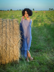 Erotic picture of Pammie Lee shows off her sexy, curvy body as she poses outdoors.