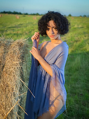 Erotic picture of Pammie Lee shows off her sexy, curvy body as she poses outdoors.