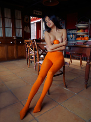 Erotic picture of Li Moon displays her smoking hot body and meaty pussy on the chair.