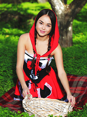Erotic picture of Li Moon sensually poses outdoors baring her delectable pussy.