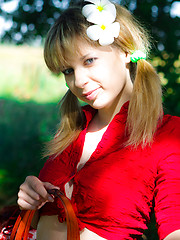 Erotic picture of Remarkable teen with a basket of apples undressing and showing breasts and pussy outdoors.