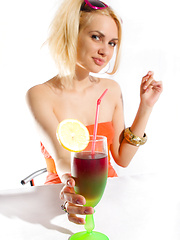 Erotic picture of Beautiful blonde teen chick with sunglasses stripping while drinking a delicious cocktail.