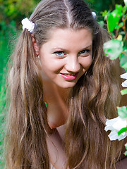 Erotic picture of Perfect long haired busty teen cutie taking off her clothes and catching a big butterfly.