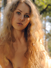 Erotic picture of Admirable naked charmer demonstrating her natural femininity and passion in the forest.
