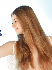 Erotic picture of Beautiful long haired teen angel in white stockings showing her body near Christmas tree.