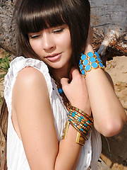 Erotic picture of Adorable dark haired honey taking off dress and demonstrating perfect body on the seaside.