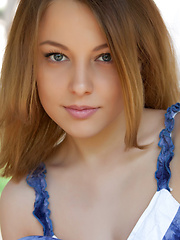 Erotic picture of One could easily get stunned and hypnotized in Nikia\'s sparkling, sexy eyes with seductive gaze as she strips her blue dress and poses naughtily all over the garden.