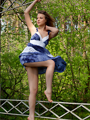 Erotic picture of One could easily get stunned and hypnotized in Nikia\'s sparkling, sexy eyes with seductive gaze as she strips her blue dress and poses naughtily all over the garden.