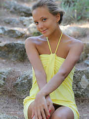 Erotic picture of With her charming, youthful allure, tanned complexion, beautiful firm breasts with puffy nipples, Mango\'s natural beauty stands out on a rocky location.