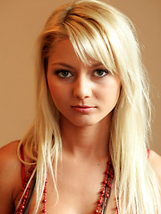 Erotic picture of This young beautiful blonde named Grace flaunts her stunning, luscious body with gorgeous, perky tits, clean shaven pussy and shapely legs as she strips her sexy red dress in front of the camera