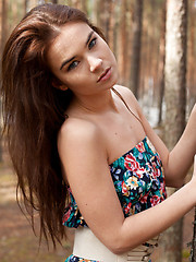 Erotic picture of Lachia overwhelming youthful beauty and carefree allure creates a stunning visual treat among the towering pine trees.