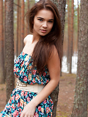 Erotic picture of Lachia overwhelming youthful beauty and carefree allure creates a stunning visual treat among the towering pine trees.