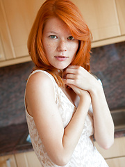Erotic picture of European redhead beauty shows her cherry on the kitchen