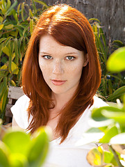 Erotic picture of Redhead Mia Solis posing outside