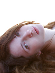 Erotic picture of Riding in a strong horse is this brunette with kinky hair and alabaster skin.