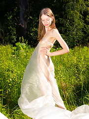 Erotic picture of Gorgeous slim girl posing absolutely naked outdoor in the field on the plastic sheeting.