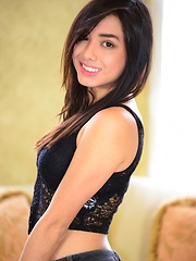 Erotic picture of Zoe Martinez strips her jeans off to reveal her black bra and panties on her all natural body