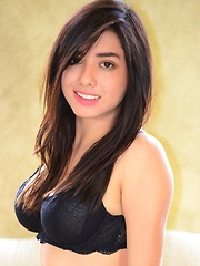 Erotic picture of Zoe Martinez strips her jeans off to reveal her black bra and panties on her all natural body