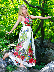 Erotic picture of Valeri's seductive face with alluring green eyes and shiny pink lips, gifted with a stunning body with gorgeous puffy breasts is an arousing sight outdoors.