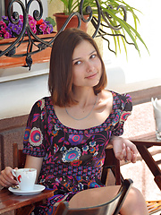 Erotic picture of Delicious dark haired sweetie undressing and posing naked outdoor on the chair in the park.