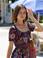 Erotic picture of Delicious dark haired sweetie undressing and posing naked outdoor on the chair in the park.