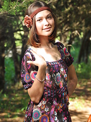 Erotic picture of Delicious dark haired sweetie undressing and posing naked outdoor on the chair in the park.