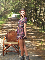 Erotic picture of Delicious dark haired sweetie undressing and posing naked outdoor on the chair in the park.