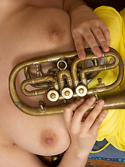 Erotic picture of Sweet as well desirable music loving girl pose in frantic yellow summer outfit. Extra busty natural boobs as well sweet smile.