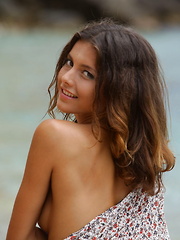 Erotic picture of Divina A enjoys a nude stroll on the beach