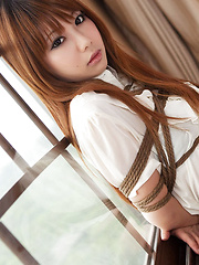 Erotic picture of Dimdim Asian in tight office skirt and blouse is tied in ropes