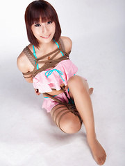 Erotic picture of Ayako Asian leering babe has big smile on face as is tied in rope