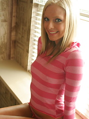 Erotic picture of Petite teen babe Skye teases with her perky tits as she lifts her pink striped shirt