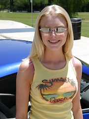 Erotic picture of Blonde teen Skye Model shows off her tight teen body by her friends car