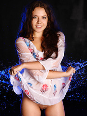 Erotic picture of Norma A pulls off her white dress and gets her body wet