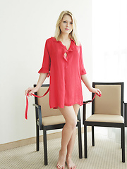 Erotic picture of Lucy Heart smooth fair skin accentuated by a red chiffon robe