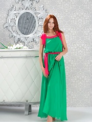 Erotic picture of Lydia A briefly poses in her green maxi dress with hot pink belt before stipping naked and playfully posing in front of Alex Iskan\'s camera