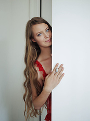 Erotic picture of Milana K strips off her sexy red nighty