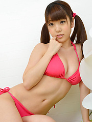Erotic picture of Mizuho Shiraishi with cans in pink bath suit plays with her hair