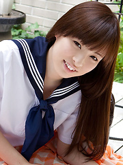 Erotic picture of Maho Kimura Asian undresses school uniform right in the park