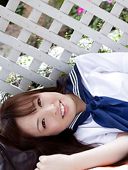 Erotic picture of Maho Kimura Asian undresses school uniform right in the park