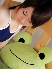 Erotic picture of Naoko Sawano Asian in bath suit puts pillow between her sexy legs