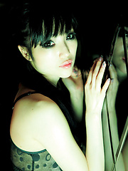 Erotic picture of Neo Asian babe with firm big boobs in kinky bra is club dancer