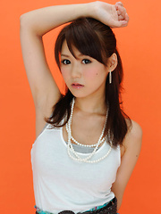 Erotic picture of Yumi Asian is such cute and playful honey in white top and skirt