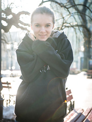 Erotic picture of Katie A evokes a striking feminine radiance and elegant composure as she poses in her black thigh-high stockings that showcase her lovely legs.