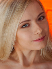 Erotic picture of Lenore makes a sizzling hot debut as she confidently poses naked on top of the sofa, her long and slender body in full view.