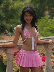 Erotic picture of Carol Lopez wears a string bikini and a pink mini skirt and she shakes that latina teen body gives us a hot strip show
