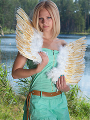 Erotic picture of Amazing blonde teen babe gets naked on the lap of nature and tries to mimic some angelic beauty with her poses.